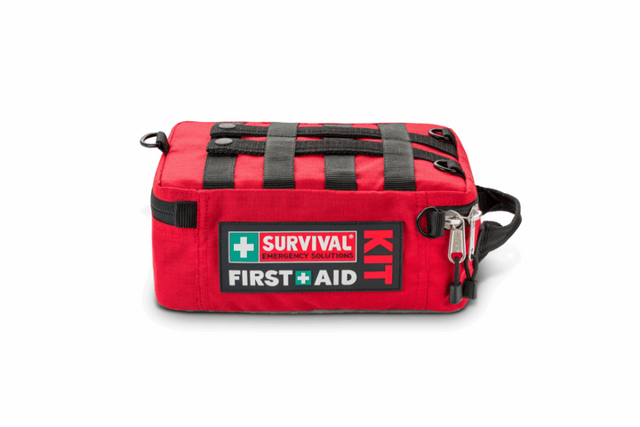 Family Survival First Aid Kit – heavy-duty red case with labeled compartments laying flat showing the molle webbing on the back which is useful for attaching to multiple objects