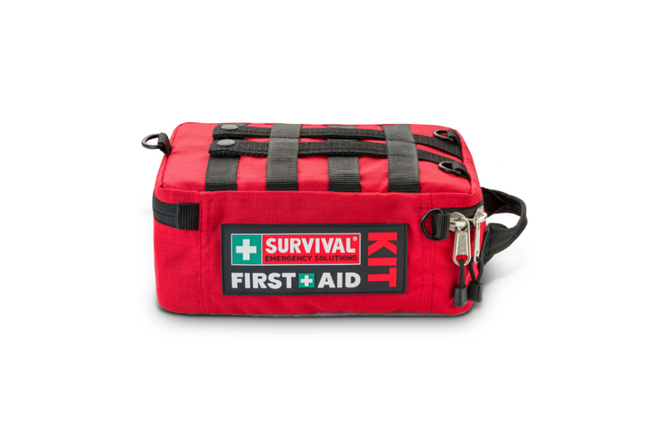Family Survival First Aid Kit – heavy-duty red case with labeled compartments laying flat showing the molle webbing on the back which is useful for attaching to multiple objects