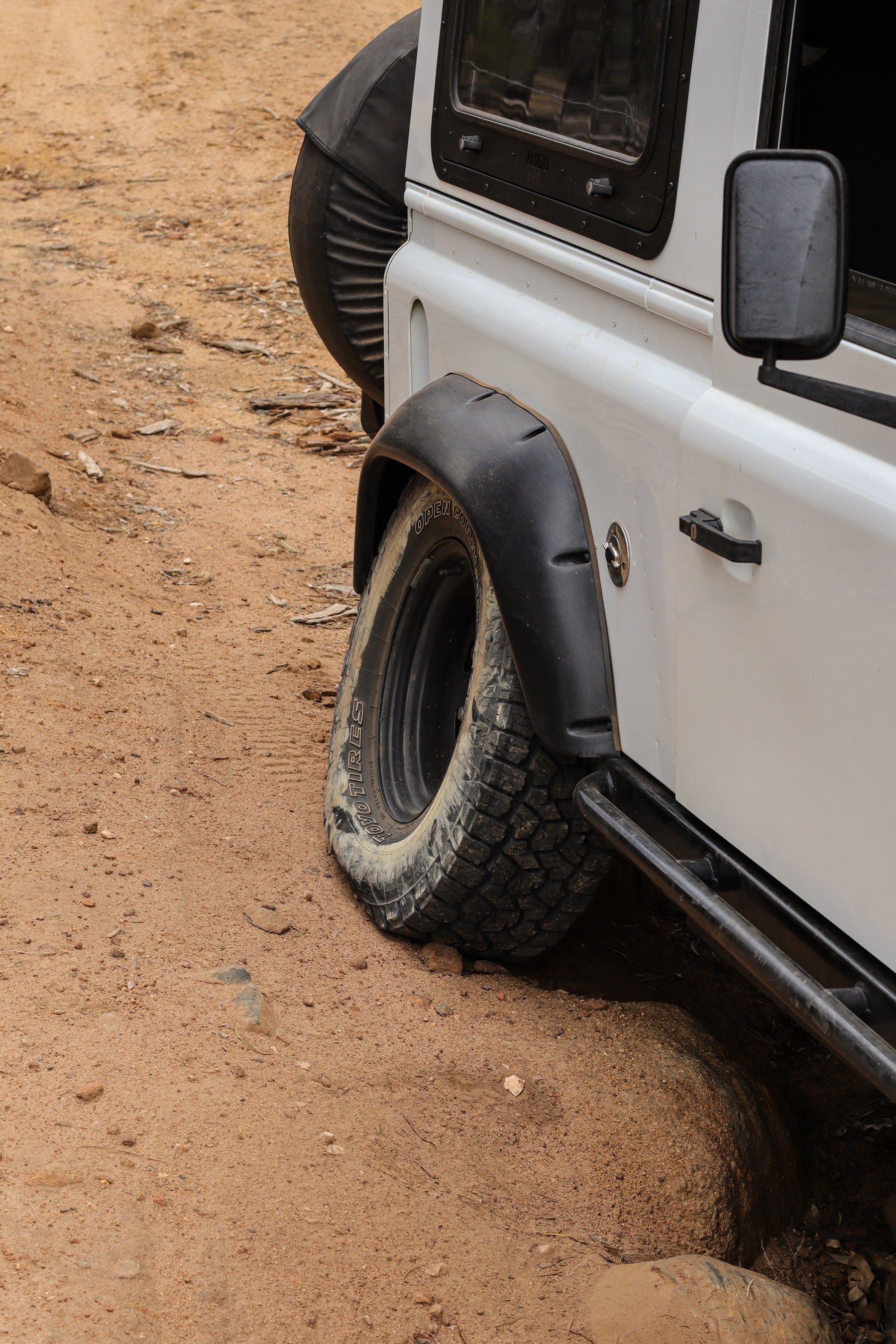 landrover defender rear tyre close u photo of tyre tucked high into the gaurd